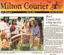 photo and caption from Milton Courier showing DA the Clown making balloon hats